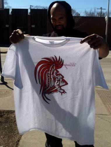 Matt Forte holding a Unique Warrior shirt